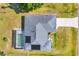 Aerial view of a home with a screened pool and large driveway at 1035 Riggs St, Port Charlotte, FL 33952