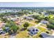 Neighborhood aerial view with mature trees surrounding well maintained homes and a pond at 1035 Riggs St, Port Charlotte, FL 33952