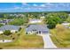 Aerial view of a charming single-story home with a well-manicured lawn at 1035 Riggs St, Port Charlotte, FL 33952