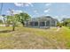 Spacious backyard with a screened-in pool enclosure at 1035 Riggs St, Port Charlotte, FL 33952