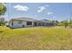 Large backyard featuring a screened pool and plenty of green space at 1035 Riggs St, Port Charlotte, FL 33952