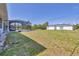Spacious backyard showcasing a screened-in pool and ample lawn area at 1035 Riggs St, Port Charlotte, FL 33952