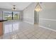 Open dining room featuring a large window and tile floors at 1035 Riggs St, Port Charlotte, FL 33952