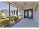 Welcoming screened entryway with double doors and decorative light fixture at 1035 Riggs St, Port Charlotte, FL 33952