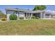 Charming single-story home with a well-manicured lawn and attached garage at 1035 Riggs St, Port Charlotte, FL 33952