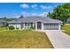 Charming single-story home with a well-manicured lawn and attached garage at 1035 Riggs St, Port Charlotte, FL 33952
