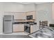 Classic kitchen featuring tile flooring, neutral cabinetry, and stainless steel appliances at 1035 Riggs St, Port Charlotte, FL 33952