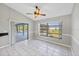 Living room with tile floors, ceiling fan and screened-in lanai access at 1035 Riggs St, Port Charlotte, FL 33952