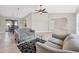 Inviting living room featuring neutral paint, ceiling fan, and views of the outdoor dining area at 1035 Riggs St, Port Charlotte, FL 33952