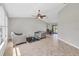 Bright living room with tile flooring, a ceiling fan, and a view of the sliding patio door at 1035 Riggs St, Port Charlotte, FL 33952