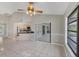Spacious room with tile flooring and view of kitchen and screened patio at 1035 Riggs St, Port Charlotte, FL 33952