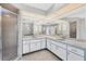 Bathroom featuring double sinks, a large mirror, and a glass-enclosed shower at 1035 Riggs St, Port Charlotte, FL 33952