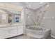 Bathroom with a large soaking tub and vanity at 1035 Riggs St, Port Charlotte, FL 33952