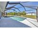 Sparkling pool surrounded by a screened enclosure and a concrete deck at 1035 Riggs St, Port Charlotte, FL 33952