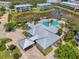 A high-angle shot captures the community center, meticulously landscaped grounds, and surrounding serene lake at 10411 Coral Landings Ln # 85, Placida, FL 33946