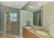 Bathroom showcasing double sinks, granite counters, and a spacious glass-enclosed shower at 10411 Coral Landings Ln # 85, Placida, FL 33946