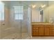 Bright bathroom with double sinks, granite counters, and spacious tiled shower with bench at 10411 Coral Landings Ln # 85, Placida, FL 33946
