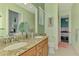 Light bathroom with dual sinks and views into the bedroom at 10411 Coral Landings Ln # 85, Placida, FL 33946