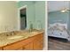 Granite-countered double sinks offer lots of space, with the bedroom visible through doorway at 10411 Coral Landings Ln # 85, Placida, FL 33946