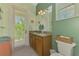 Bright bathroom with granite counters and balcony access at 10411 Coral Landings Ln # 85, Placida, FL 33946