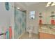 Stylish bathroom features a shower with patterned curtain, decorative fish art, and granite countertop at 10411 Coral Landings Ln # 85, Placida, FL 33946