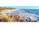 Beautiful beach scene featuring clear water, sandy shores, and inviting waves at 10411 Coral Landings Ln # 85, Placida, FL 33946