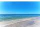 Calm turquoise ocean water meets the sandy beach at 10411 Coral Landings Ln # 85, Placida, FL 33946