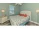 Light and airy bedroom with sand-inspired comforter, coastal decor, and bright window at 10411 Coral Landings Ln # 85, Placida, FL 33946
