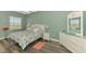 Comfortable bedroom with hardwood floors, a large window and nautical themed decor create a relaxing space at 10411 Coral Landings Ln # 85, Placida, FL 33946
