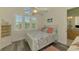 Cozy bedroom with bright windows and beach-themed decor at 10411 Coral Landings Ln # 85, Placida, FL 33946