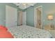 Bright bedroom featuring coastal-inspired decor, ceiling fan, and doorways to other rooms at 10411 Coral Landings Ln # 85, Placida, FL 33946
