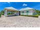 Exterior of a light yellow single-story building with white trim and a porte-cochère with brick paving at 10411 Coral Landings Ln # 85, Placida, FL 33946