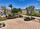 Inviting gated entrance showcasing lush landscaping and a well-maintained brick driveway at 10411 Coral Landings Ln # 85, Placida, FL 33946