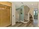 Hallway featuring wood floors, elevator access, staircase, and view to front windows at 10411 Coral Landings Ln # 85, Placida, FL 33946