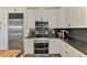 Modern kitchen features stainless appliances, white cabinets, and sleek black countertops at 10411 Coral Landings Ln # 85, Placida, FL 33946