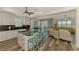 Open concept kitchen and living room with hardwood floors, island seating, and neutral color palette at 10411 Coral Landings Ln # 85, Placida, FL 33946