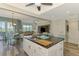 Open concept kitchen with white cabinets, large island, and views to the living area at 10411 Coral Landings Ln # 85, Placida, FL 33946