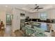Bright open concept kitchen with granite countertops, center island, and stainless steel appliances at 10411 Coral Landings Ln # 85, Placida, FL 33946