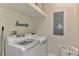 Bright laundry room with modern LG washer and dryer, shelving, and laundry accessories at 10411 Coral Landings Ln # 85, Placida, FL 33946