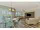 Open living area featuring a dining table, leather sofa set, and entertainment center at 10411 Coral Landings Ln # 85, Placida, FL 33946