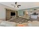 Modern living room featuring hardwood floors, a ceiling fan, and entertainment center with TV and sliding doors at 10411 Coral Landings Ln # 85, Placida, FL 33946