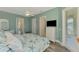 Well-lit main bedroom with TV, balcony access, and wood-look floors at 10411 Coral Landings Ln # 85, Placida, FL 33946