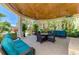 Picturesque outdoor patio with comfortable seating, ceiling fans, and views of tropical landscaping at 10411 Coral Landings Ln # 85, Placida, FL 33946