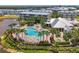 Stunning community pool area with lush landscaping, lounge chairs, and community buildings at 10411 Coral Landings Ln # 85, Placida, FL 33946