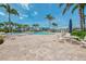 Expansive pool deck features comfortable lounge chairs, serene pool views, and meticulous landscaping at 10411 Coral Landings Ln # 85, Placida, FL 33946