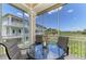 Inviting screened-in porch with table and chairs is perfect for enjoying the outdoor scenery at 10411 Coral Landings Ln # 85, Placida, FL 33946