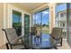 Cozy screened-in porch with seating offers a peaceful outdoor space to unwind and enjoy the views at 10411 Coral Landings Ln # 85, Placida, FL 33946