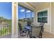 Screened-in porch with outdoor seating provides a relaxing space to enjoy the views at 10411 Coral Landings Ln # 85, Placida, FL 33946