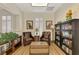 Cozy sitting area with leather chairs, book shelves, charming decor, and ample natural light at 10411 Coral Landings Ln # 85, Placida, FL 33946