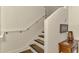 Staircase featuring wooden steps and white walls, with artwork and decor enhancing the space at 10411 Coral Landings Ln # 85, Placida, FL 33946